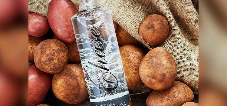 Chase potato vodka bottle among potatoes and burlap